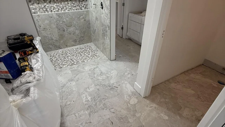 Sanchez Way: Shower threshold and adjacent floor tile